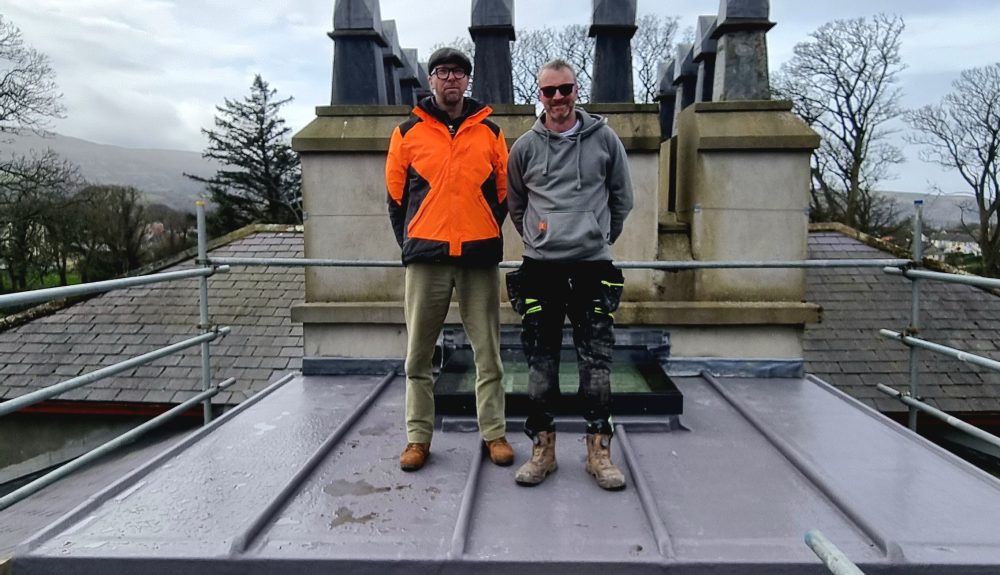 Colour photograph of Image caption MNH Historic Buildings Architect John Paul Walker (left), pictured on the roof of the Grove Museum with Gavin Edwards of GEAK Ltd (right).
